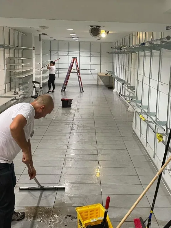 Squeegeeing water off a store floor