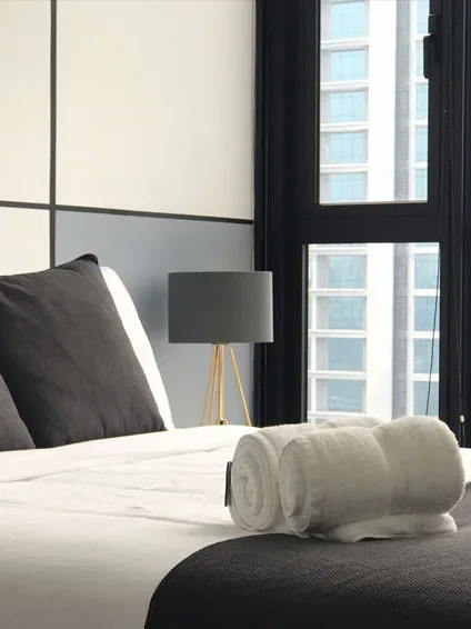 Made bed with fresh towels