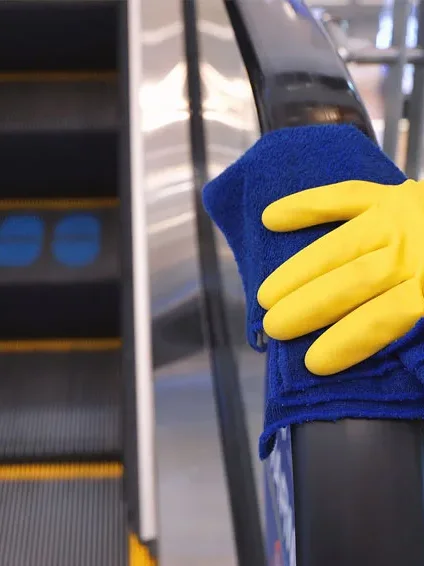 Wiping down an escalator rail
