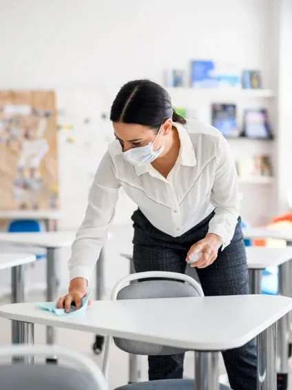 Disinfecting a student desk